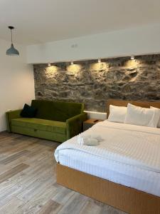 a bedroom with a bed and a green couch at RestArt Boutique Hotel in Dilijan +96 photos