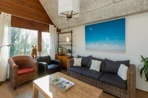 a living room with a couch and a table at Welcome in - Appartement met balkon in Veere I Kievitenlaan 22 in Veere +55 photos