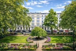 a park in front of a large white building at Seven Paddington in London