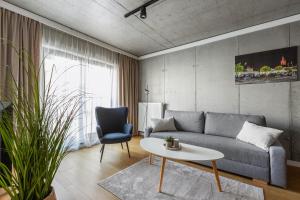 a living room with a couch and a table at River Side Apartments in Oświęcim +28 photos