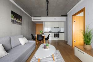 a living room with a couch and a table at River Side Apartments in Oświęcim
