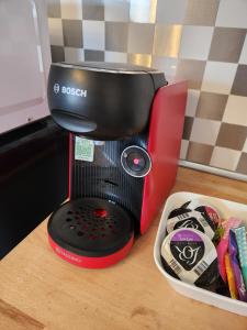 a red and black blender sitting on a table at Mareva House - Discreet with parking in Gignac-la-Nerthe