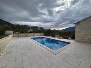 a swimming pool in the middle of a patio at Villa Lovorno in Arbanasi