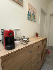 a kitchen counter with a red appliance on top of it at Casa della Cittadella in Noto