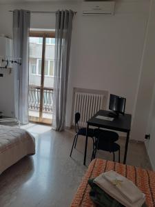 a bedroom with a desk and a bed and a table at Fashion room in Altamura