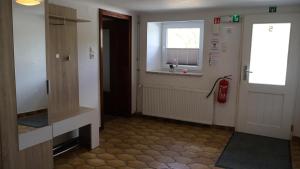 a hallway with a door and a window at Haus Wangen in Dürler
