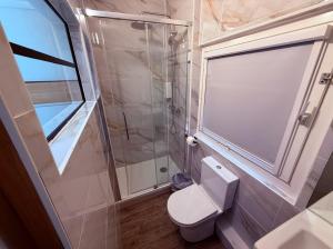 a bathroom with a toilet and a glass shower at Class'eco Charleroi in Charleroi +39 photos
