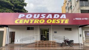 a motorcycle parked in front of a corrientosa centro office at Pousada Centro Oeste in Trindade
