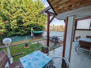 a patio with a table and chairs on a balcony at Beta Apartman in Bük