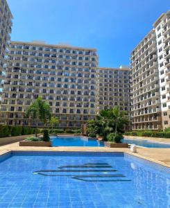 a large apartment building with a large swimming pool at AAvista in Basbas