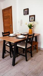 a dining room table with chairs and a vase with flowers at Ankara Residence in Santo Domingo +2 photos