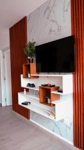 a living room with a flat screen tv on a wall at Ankara Residence in Santo Domingo
