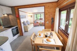 a small kitchen and living room in a tiny house at Neaum Crag Lodge ideal for a couple or family with young children in a woodland setting at Skelwith Bridge in Grasmere