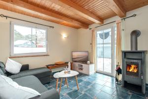 a living room with a couch and a fireplace at Ferienhaus Seestern - Bade- & Saunawelt täglich inklusive in Baabe