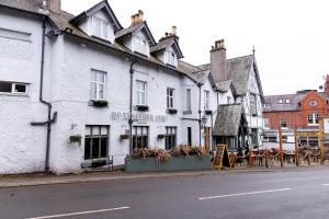 a white building on the side of a street at De Trafford Arms by Chef & Brewer Collection in Alderley Edge