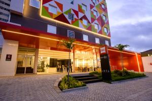a large building with a restaurant in front of it at Ibis Caruaru in Caruaru
