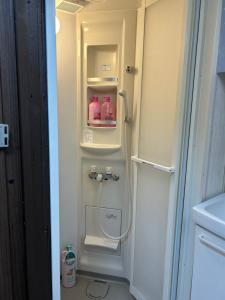 a refrigerator with its door open in a kitchen at 馨誠小屋201 in Tokyo +25 photos