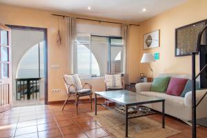 a living room with a couch and a table and chairs at Terraza al Mar La Fosca in Palamós