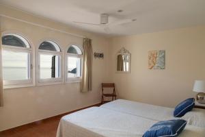 a bedroom with two beds and two windows at Terraza al Mar La Fosca in Palamós