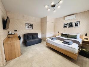 a bedroom with a bed and a chair at Old Friend Guest House in Berehove