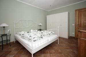 a bedroom with a white bed and a table at VillaLimone in Limone sul Garda