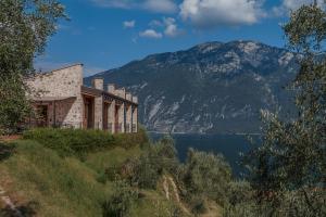 a building on a hill next to a body of water at VillaLimone in Limone sul Garda
