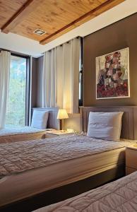 a bedroom with two beds and a window at Picasso Guesthouse in Mokpo