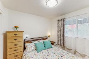 a bedroom with a bed and a dresser and a window at Mountain-View Patio, 1 Mi From UO Campus in Eugene