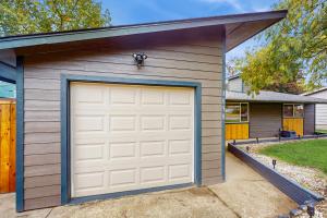 a garage with a white garage door in front of a house at Mountain-View Patio, 1 Mi From UO Campus in Eugene