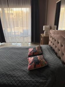 a bedroom with a bed with two pillows on it at Lambertu ielas rezidence in Mārupe