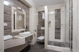 a bathroom with a toilet and a sink and a shower at Mattes Restaurant & Pension in Držovice +51 photos