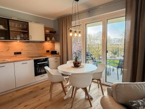 a kitchen and dining room with a table and chairs at Ferienwohnung Gartenidyll am Dümmer See in Lembruch +18 photos