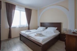 a bedroom with a large bed with a large window at Mattes Restaurant & Pension in Držovice