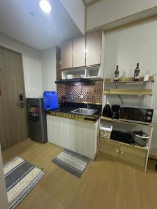 a kitchen with a sink and a counter top at HOPE RESIDENCES UNIT 606 building D in Trece Martires