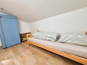 a bedroom with a bed and a mirror at Sonnenblumen in Hörbranz