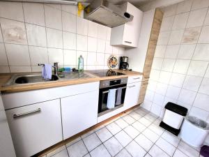 a small kitchen with a sink and a stove at Sonnenblumen in Hörbranz +5 photos