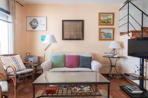 a living room with a couch and a table at Terraza al Mar La Fosca in Palamós