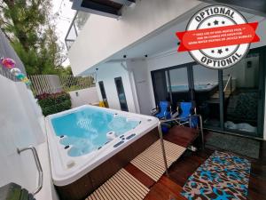 a hot tub in the backyard of a house at Salablanca Brand New Jacuzzi Heated Pool PS5 VR Cinema Fully AC Indoors Smart TVs with Netflix Disney Plus Large Balcony in Tagaytay