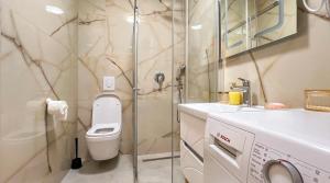 a bathroom with a toilet and a glass shower at Harmony Apartment 2 in Bar +14 photos