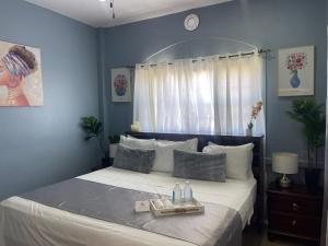 a bedroom with a bed with a tray on it at The Colosseum St Kitts in Basseterre +33 photos