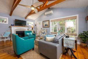 a living room with a couch and chairs and a fireplace at Colonels Quarters in Kennebunk