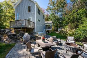 a patio with a table and chairs and a house at Colonels Quarters in Kennebunk