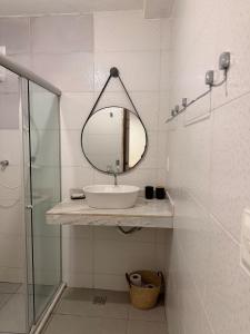 a bathroom with a sink and a mirror at Casinha Verde, Itacaré in Itacaré +26 photos