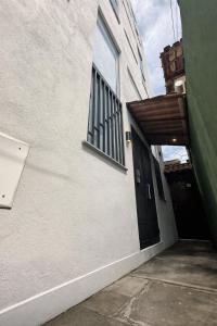 an entrance to a building with a black door at Casaboa Apartamentos Passarela in Itacaré