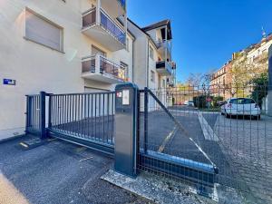 a fence in front of a building with a parking meter at Pearly EuroPoint in Saint-Louis
