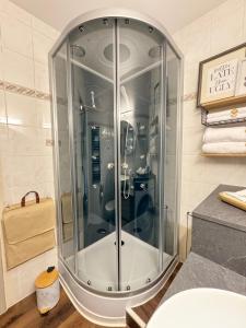 a shower with a glass door in a bathroom at Pearly EuroPoint in Saint-Louis +51 photos