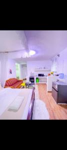 a large white room with a bed and a couch at R 19 Kogelo Villas in Kisumu