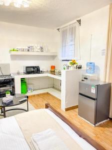 a kitchen with a refrigerator and a table in a room at R 19 Kogelo Villas in Kisumu +2 photos