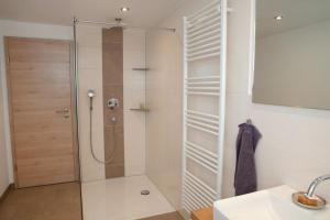 a shower with a glass door in a bathroom at Bauernhaus Markus Köpf in Füssen +34 photos