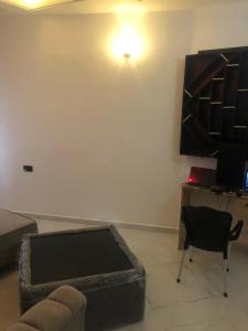 a living room with a couch and a desk at The 7th Haven in Uyo